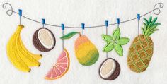 some fruit is hanging on a line with clothes pins attached to it and there are bananas, oranges, lemons, and pineapples