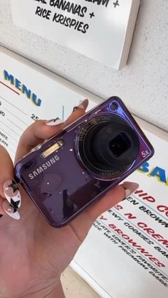 a person holding a purple camera in their hand