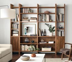 a living room filled with furniture and bookshelves