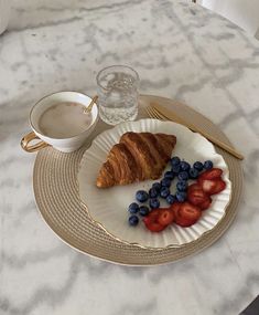 croissant, strawberries and blueberries on a plate