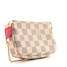 This is an authentic LOUIS VUITTON Damier Azur 2021 Christmas Animation Hollywood Mini Pochette Accessories in Fuchsia. This pochette is crafted of traditional Damier white and blue checkered in toile canvas with a colorful design of the Vivienne doll in Hollywood. The pochette features a gold-plated chain-link wristlet strap and a matching top zipper that opens to a compact pink fabric interior. Mini Pochette Accessories, Christmas Animation, Pochette Accessories, The Vivienne, Blue Checkered, Louis Vuitton Damier Azur, Colorful Design, Matching Top, Pink Fabric