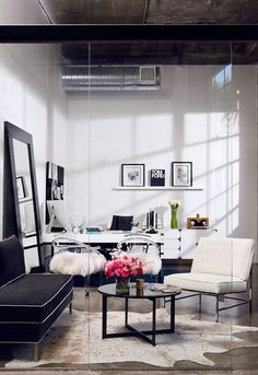 a living room filled with furniture and a large mirror on the wall above it's coffee table