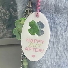 a close up of a key chain on a stuffed animal with a happy ever after tag