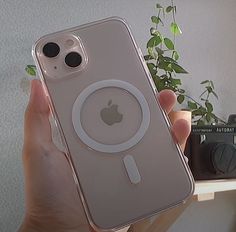 a person holding up an iphone case that has a camera attached to the back of it