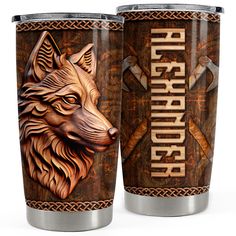 two stainless steel tumblers with an image of a wolf and crossed swords on them