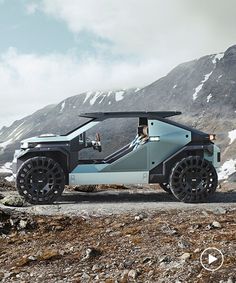 an electric vehicle is parked on the side of a mountain road