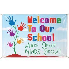 a welcome to our school sign with hand prints on the front and back of it