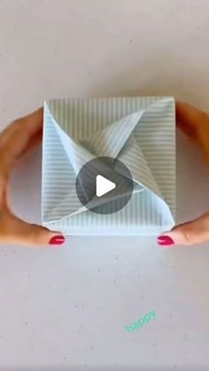 two hands holding an origami envelope