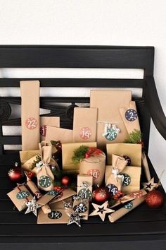 christmas presents are wrapped in brown paper and placed on a bench