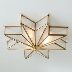 a ceiling light that has been designed to look like an origami star with three lights on each side