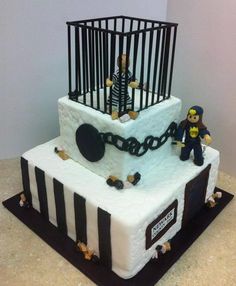 a birthday cake with a jail cell theme on the side and a toy figure in front