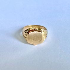 a gold signet ring with an elephant on it