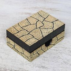 a small box that has some kind of design on it, sitting on a table