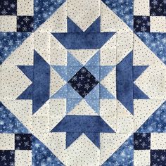 a blue and white quilt with stars in the center on it's side,