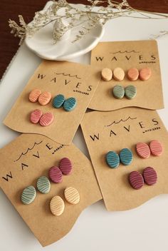 four pairs of wooden earrings on top of a table