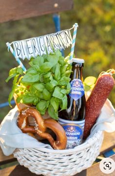 a beer and pretzel arrangement in a basket on a wooden chair with grass