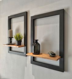 two wooden shelves with vases and plants on them