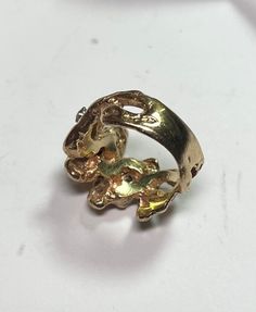 . Very cool poured gold Nugget ring in size 6. Very easy to wear and a nice heavy feel. 3 .05ct round brilliant cut diamonds. Circa 1985. 9.13 grams 14 karat yellow gold 0.15 carats I-J SI round brilliant cut diamonds Size 6 Elegant Nugget Diamond Ring For Anniversary, Unique Gold Ring With Prong Setting, Unique Gold Diamond Ring With Prong Setting, Unique Gold Round Cut Diamond Ring, Unique Gold Diamond Ring With Round Cut, Unique Collectible Diamond Rings, Unique Gold Oval Diamond Ring, Gold Oval Diamond Ring With Unique Style, Unique Gold Rings With Diamond Accents