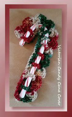 two crocheted christmas candy canes are on the floor next to each other