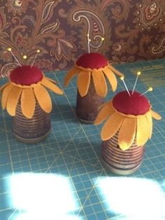 three vases with flowers are sitting on a table