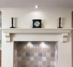 a clock on top of a mantle in a room with white walls and tile flooring