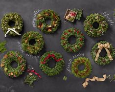 christmas wreaths and ribbons laid out on a chalkboard