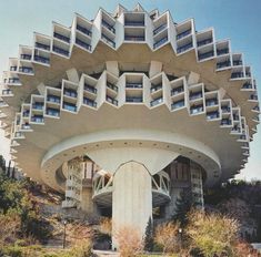 an unusual building with multiple balconies on top