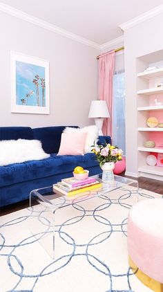 a living room with pink, blue and white furniture