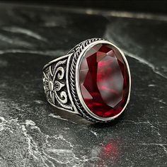 Men Silver Red Garnet Stone Ring , Men Red Ruby Gemstone Ring , Turkish Handmade Jewelry , Floral Style , Men Silver Jewelry , Gift For Him , Same Day For Shipping ✧ Product Details * Handmade İtem * Gender : Male / Female * Material : 925K Sterling Silver * Ring Weight : 13 Grams * Gemstone Type : Red Garnet ✔ Usage Details * Silver jewelry is very sensitive to chemicals. It is recommended to keep away from chemical substances such as cream, bleach, deodorant, detergent. * Silver jewelry can also darken quickly in salt water, that is, in sea water. For this reason, it is best to remove them when swimming in the sea. ✔ Shipping * Your orders placed on weekdays are delivered to the cargo on the same day. Your orders placed on the weekend are delivered to the cargo on Monday. ✔ Other Details Luxury Red Gemstone Men's Ring, Men Silver Jewelry, Stone Ring Men, Garnet Stone Ring, Chemical Substances, Ring Men, Red Band, Garnet Stone, Ruby Gemstone