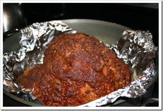 a meatball in foil sitting on top of a stove