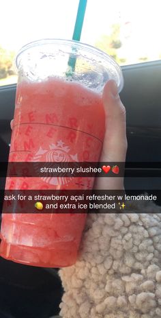 a person holding a drink in their hand with the words strawberry slushee on it