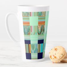 a cup and cookie sitting next to each other