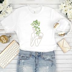 floral shirt, t shirts for women, aesthetic shirt, gifts for her, trendy shirts, teen girl shirt, botanical shirt 👕 Wonderful t-shirt will create a fascinating look! Perfect gift for girls and women. This floral t shirt will become the favorite part of your outfit! ►CLASSIC FIT Our unisex T-shirts are true to size. Look amazing with our graphic tee! Due to the comfortable fitting, the floral print T-shirt will favorably accentuate your figure. Great for sports, outdoor activities, etc. Made from soft and breathable material that is pleasant to the skin! ►COOL GIFT Give your family members or friends a floral shirt, impress them! The flower T-shirt is a unique gift for any occasion: * Birthday * Christmas * Graduation * Anniversary * Halloween, etc. ►DETAILS * Unisex * For kids and adults Trendy Crew Neck Shirt With Plant Print, White Aesthetic Summer Tops, Trendy Short Sleeve Shirt With Plant Print, Aesthetic Graphic Print Tops For Spring, Trendy Cotton T-shirt With Plant Print, Aesthetic Graphic Print Tops For Summer, Spring Aesthetic Graphic Print T-shirt, Spring Aesthetic Graphic T-shirt, Aesthetic Relaxed Fit T-shirt For Summer