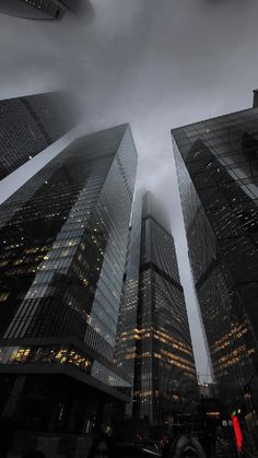 some very tall buildings under a cloudy sky