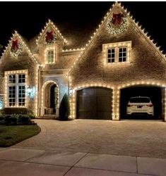 a car is parked in front of a house decorated with christmas lights