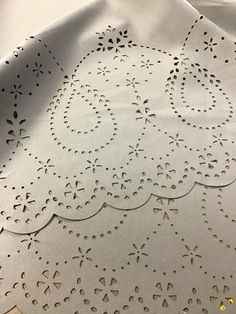 a white table cloth with cut outs on it