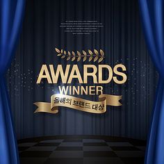 the awards winner is standing in front of blue curtains with gold ribbon and laurels