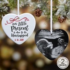 two heart shaped ornaments hanging from a christmas tree