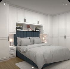 a bedroom with white cabinets and gray bedding