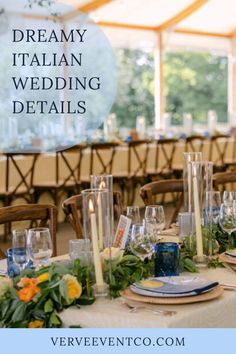 a table set up for a wedding with candles and flowers