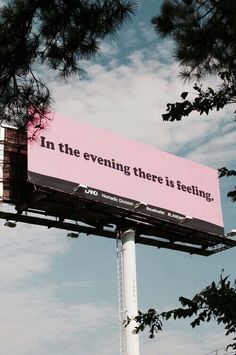 a pink billboard with the words in the evening there is feeling on it's side