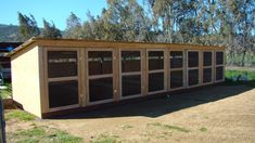 a small shed with several windows on the side