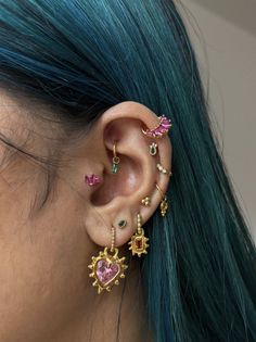 a woman with blue hair wearing ear piercings