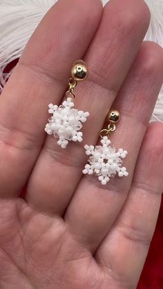 the snowflake earrings are made from tiny beads