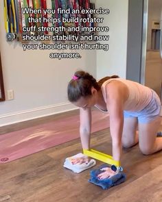 a woman kneeling down on the floor with a mop