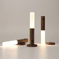 three different types of lights are shown on the table, and one is made out of wood