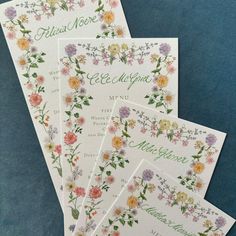 four cards with floral designs on them sitting next to each other