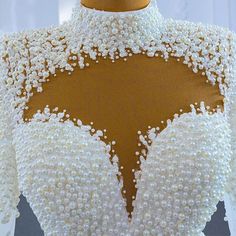 the back of a dress with pearls on it