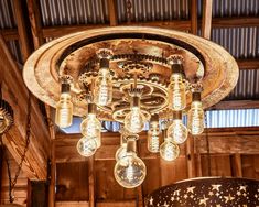 a chandelier hanging from the ceiling in a barn