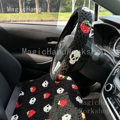 a car seat covered in a crocheted skull and strawberry blanket